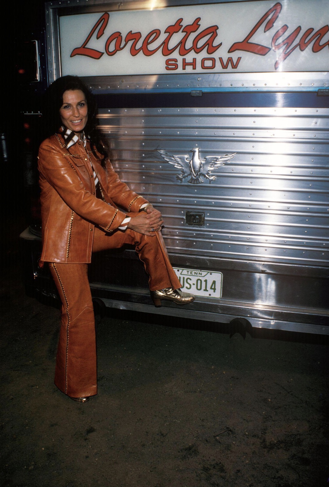 Loretta Lynn posing with her tour bus 
